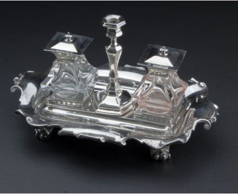 H. Wilkinson and Co.,  a silver inkstand having twin swept square hinged lidded wells and a knopped candle stand, on a scroll