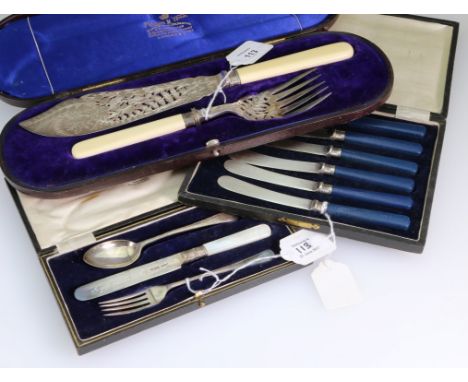 W. S. S. and Co., a cased silver three piece christening set, a cased set of six butter knives with silver collars and bakeli