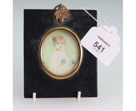 Early 20th century British School A three quarter length portrait miniature of a young fair haired  boy holding two blue sphe