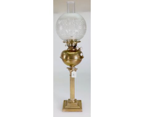 An Edwardian paraffin lamp, having clear chimney, etched spherical shade, bun form brass reservoir, Corinthian column and ste