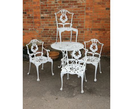 A suite of white painted cast aluminium garden furniture, comprising circular table and four chairs, each leaf decorated on c