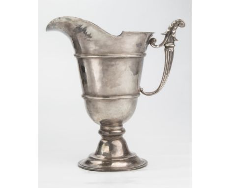 An early 20th century Duchess of Sutherland's Cripple Guild silver plated helmet ewer, with leaf capped handle and hammered a