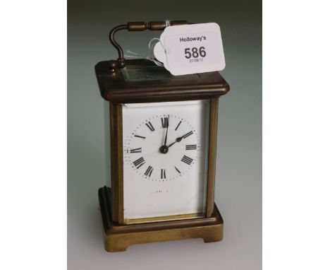 An early 20th century brass cased five glass carriage timepiece, eight day movement, enamel Roman dial and bail handle, 15cm 