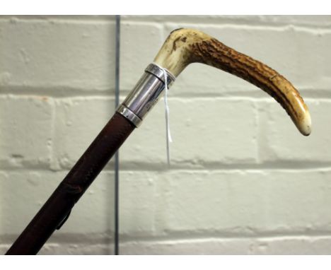 Swaine and Adeney, a hunting crop, having antler handle with button, silver collar, leather covered shaft and thong, London 1