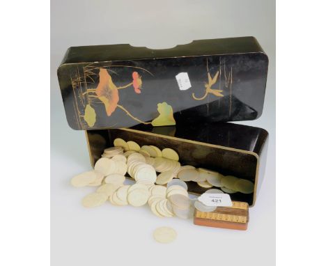 A Japanese black lacquered glove box and cover, with counters of 19th century Chinese circular mother of pearl and bone gamin