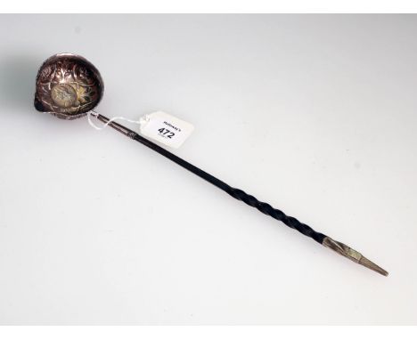 A Victorian toddy ladle, the florally pressed white metal bowl set with George II silver coin from a wrythen whale bone handl