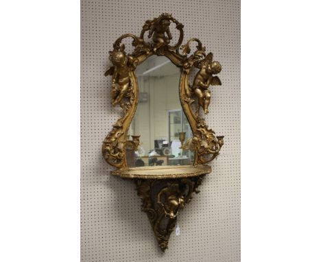 A 19th century style carved wood and gesso girandole, with courting cherubs to the cartouche, frame fitted with four sinewy s