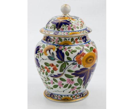 A 19th century English porcelain covered jar, of baluster form withy knop finial, decorated with sunflowers, cobalt blue and 