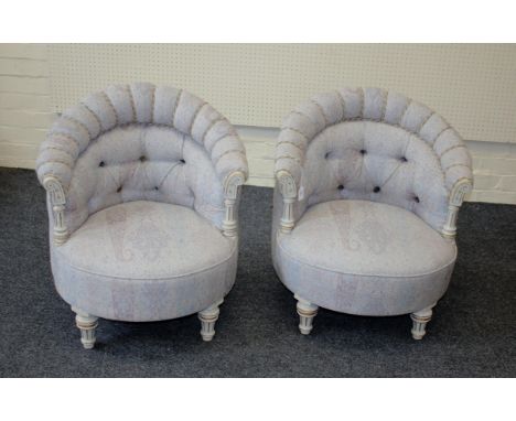 A pair of Edwardian grey painted and button upholstered tub salon chairs, raised on turned supports