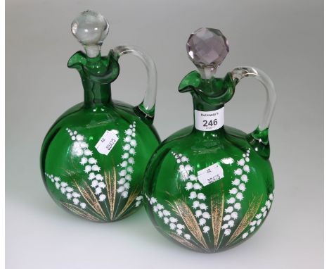 A pair of Victorian green glass spirit flasks, each having clear loop handle and wavy rim, the body decorated wit sprays of w