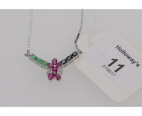A sapphire, ruby, emerald and diamond necklace, in the form of a central ruby and diamond cluster with three stone emerald an