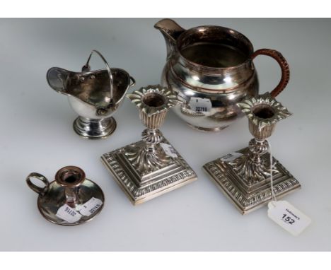 A pair of silver plated squat wrythen form table candlesticks, with loaded bases, 11cm, a silver plated helmet shape cream ju