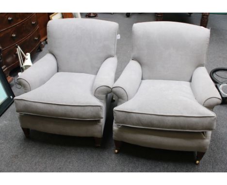 A pair of early 20th century drawing room armchairs, each having rolled back and arms, deep seat, on square tapering fluted m