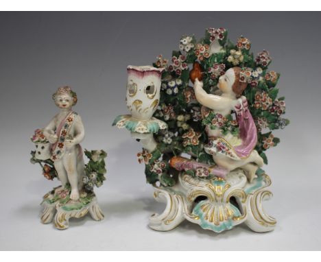 A Derby porcelain candlestick group, circa 1770, modelled as Cupid retrieving a flaming heart from bocage, a quiver of arrows