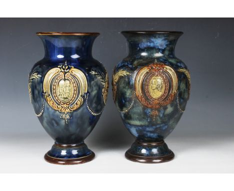 A pair of Royal Doulton stoneware vases, early 20th century, relief decorated with a portrait of a young girl opposing a youn