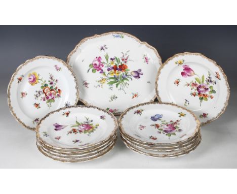 A set of twelve Meissen porcelain outside factory painted dessert plates, early 20th century, with floral bouquets and scatte