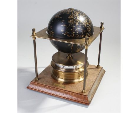 The Royal Geographical Society World Clock, the black gilded globe within a square brass platform over a drum clock with hori