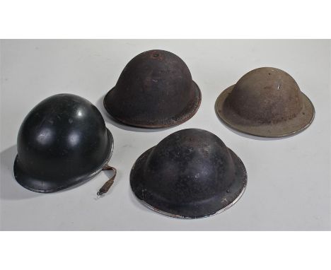 Four helmets, to include a Falklands War period helmet, two home guard helmets and another, (4)