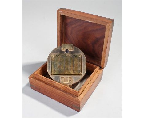 Brass compass, the hinged case enclosing the compass, housed within a anchor inlaid case