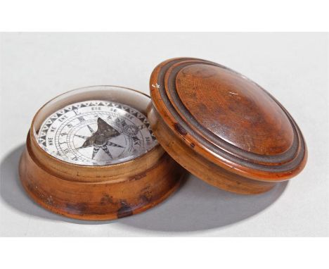 19th Century turned yew wood pocket compass, the dome top enclosing a glazed dome top and paper compass, 60mm diameter 