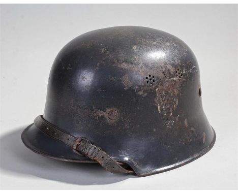 German Second World War helmet, the traces of the white shield and eagle paint remaining, overall deep green painted