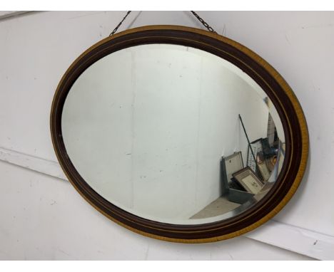 An oval inlaid mirror and another.W:83cm x D:cm x H:58cm
