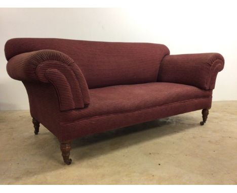 An upholstered two seater sofa on turned feet with metal castors. W:185cm x D:90cm x H:84cm