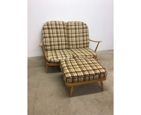 A Ercol style two seater beech framed sofa with a Ercol stamped matching foot stall