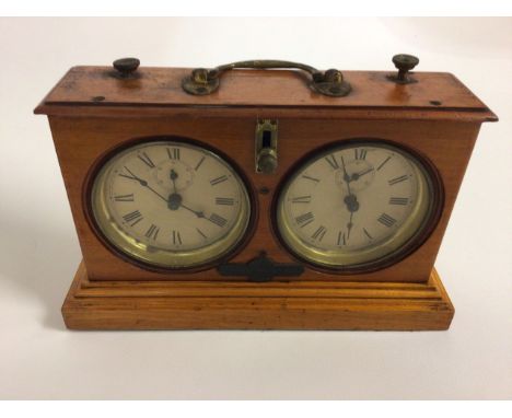 A Jaques & Son satinwood. Congress Chess Timer with twin dials having seconds dials, a going/stop lever, and brass carrying h