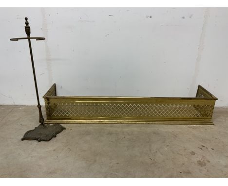 A brass fender also with a brass stick stand.W:124cm x D:30cm x H:20cm