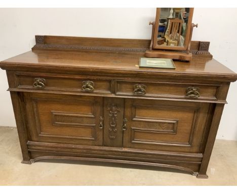 A solid oak sideboard with brass handles also with a mirror and an etching.W:78cm x D:60cm x H:117cm