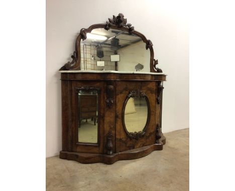 A Victorian walnut veneered wash stand with marble top and mirror. With carved acorns and foliage with three mirrored doors t