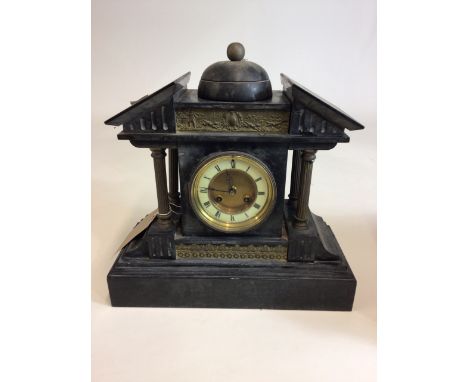 J. Unghans - a German slate and gilt brass mantle clock of architectural form with roof like pediment, flanked by gilt column