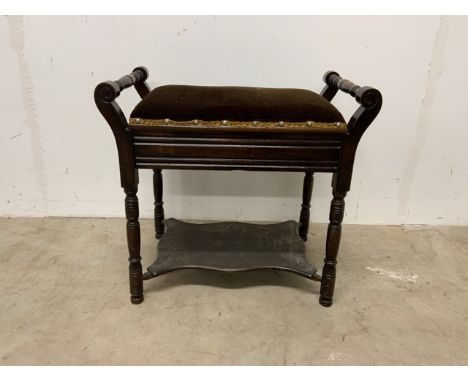 A mahogany piano stool with lift up lid and upholstered seat and shelf below.W:54cm x D:34cm x H:52cm