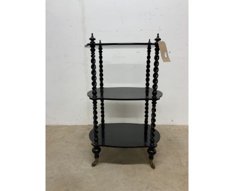 A black painted three tier trolley in the style of Gillows and Collier. Castors marked Cope Collinson Strong with middle shel