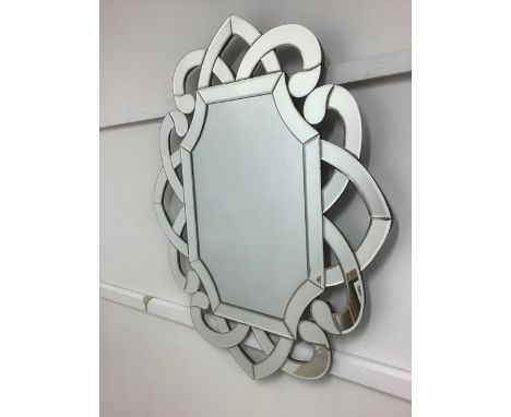 A modern pierced knot work wall mirror. W:74cm x D:2cm x H:90cm