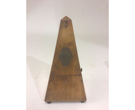 A Maelzel Paquet 1846-1915 walnut cased pyramid shaped metronome raised on bun feet, no. 438,300 complete with weighted pendu