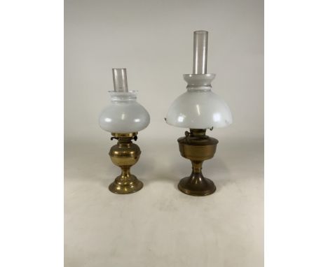 An Aladdin brass oil lamp with another brass lamp