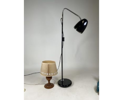 A black articulated lamp with adjustable head together with a wooden turned lamp. Black lamp: H:150cm approx. 
