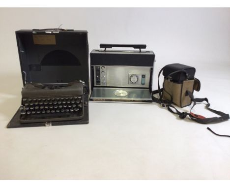 A Imperial Model T type writer, a Zenith radio and a Kodak Instamatic video camera. 