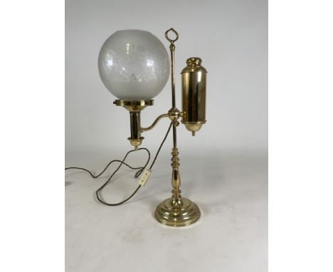 An Edwardian brass table lamp(converted) with frosted glass shade.  H:58cm