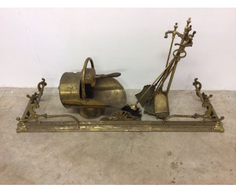 A brass fire guard with fire tools and coal scuttle. 