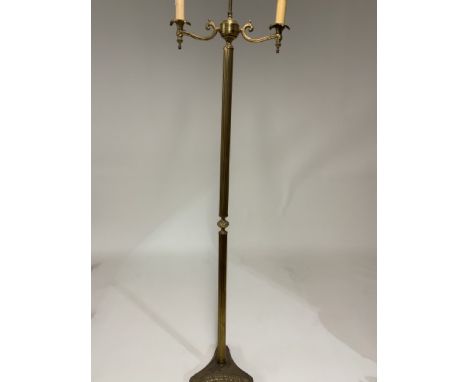 A brass candelabra style standard lamp with triangular base 