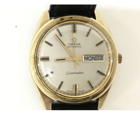 A vintage automatic Omega Seamaster day date watch. 36mm case with a silver dial. Replacement leather strap. Watch running. N