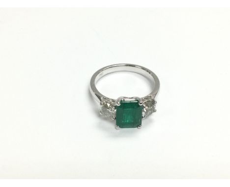 A certificated 18ct white gold p, emerald and diamond trilogy ring. Octagonal step cut emerald approx 1.50ct, RBC diamonds 0.