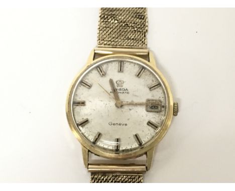 A vintage Omega Geneve gents watch. Silver dial. 9ct gold strap. Case is 35mm. Watch winds and runs. No box or papers.