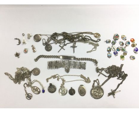 A collection of silver jewellery items including a gate bracelet, cross pendants, St Christopher etc. Shipping category A.