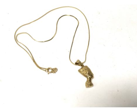 An 18ct gold chain with an attached gold Nefertiti pendant. Approx weight 5.40 grams.