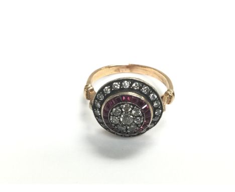 A certificated vintage style 8ct rose gold, silver top, target style ring set with transitional cut diamonds and step cut rub