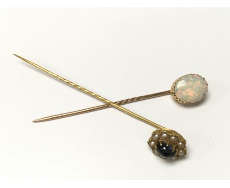 A large Opal set stick pin together with a star sapphire and seed pearl stick pin, both gold mounted. Postage Category A.